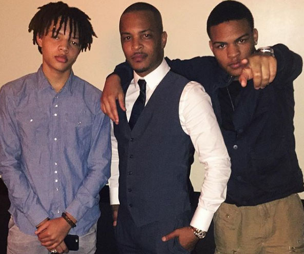 Messiah taking a picture with his father TI and the brother Domani.